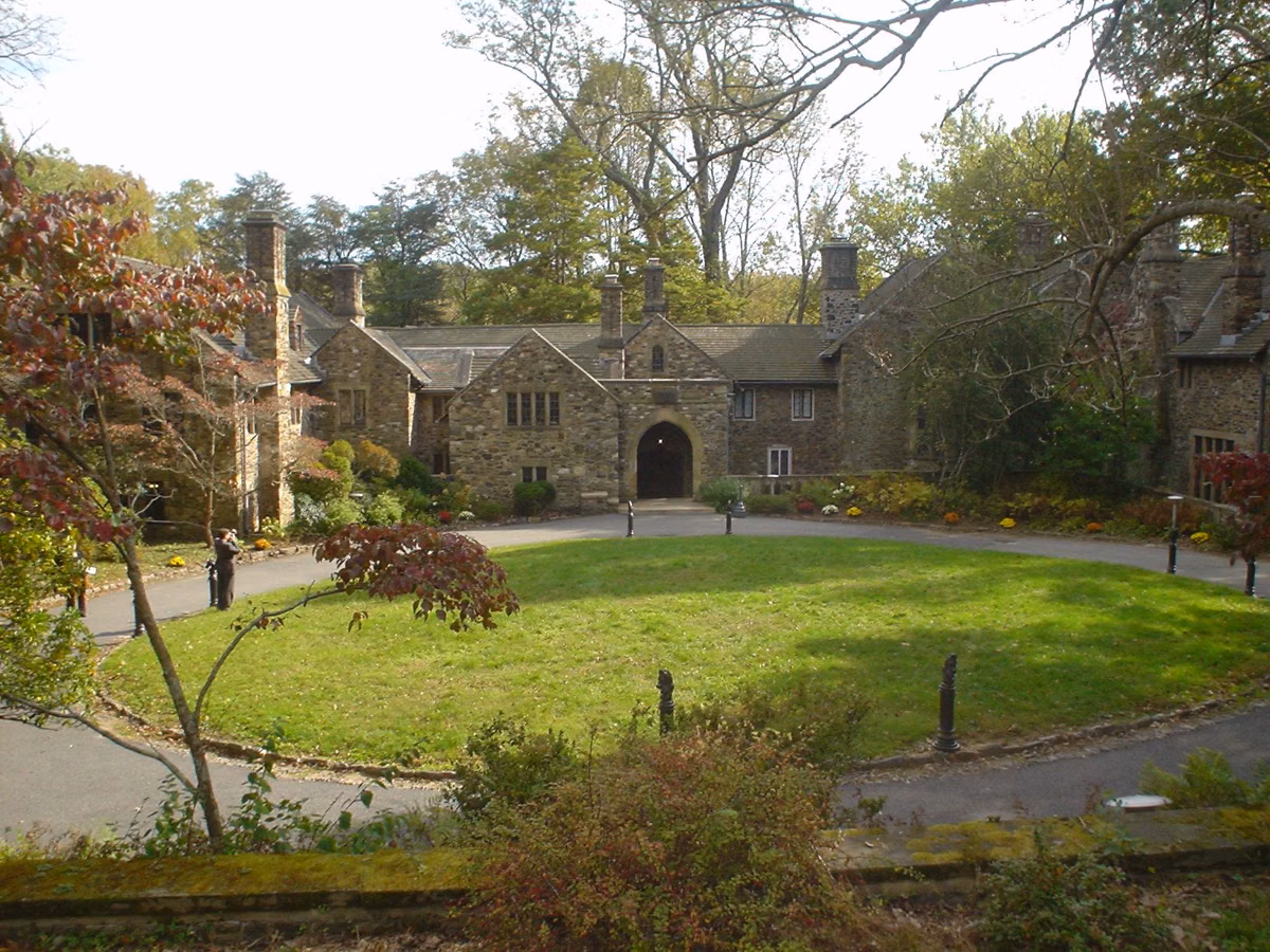 Hunting Hill Mansion, the gray stone park office at Ridley Creek State Park, behind a circular lawn and drive